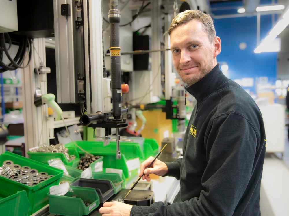 Fredrik Andmarken, an Öhlins employee, at his workstation assembling suspension in the factory.